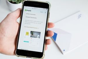 A phone showing a shopify paymen processing page on screen